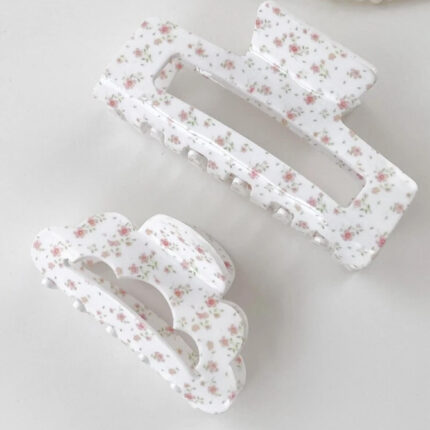 Floral rectangle claw clip styled next to beauty and hair accessories in a gift box