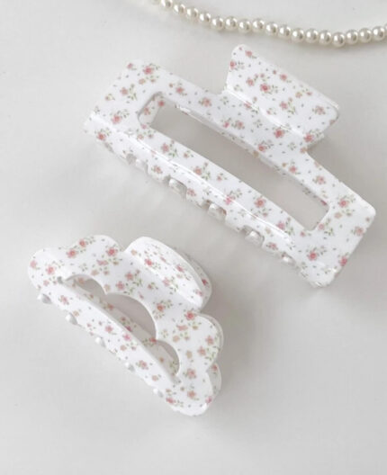 Floral rectangle claw clip styled next to beauty and hair accessories in a gift box