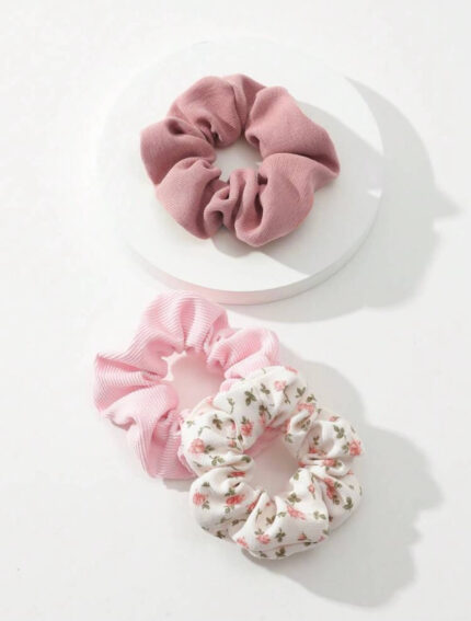 Pack of floral and rib knit scrunchies displayed on a wooden surface with delicate flowers