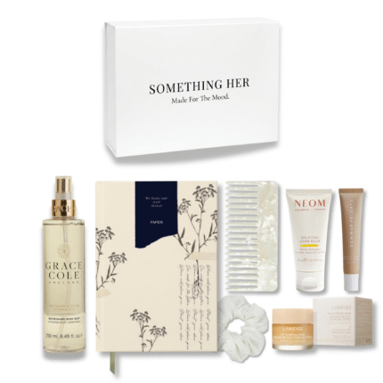 Evening self-care box with notebook, hand cream, lip balm, mist, comb, and silk scrunchie in a relaxing neutral-toned gift set