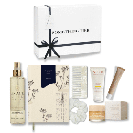 Evening self-care box with notebook, hand cream, lip balm, mist, comb, and silk scrunchie in a relaxing neutral-toned gift set