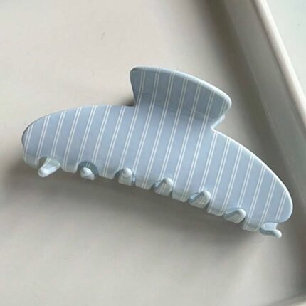 Striped blue oval claw clip hair accessory for secure and stylish everyday hairstyles.